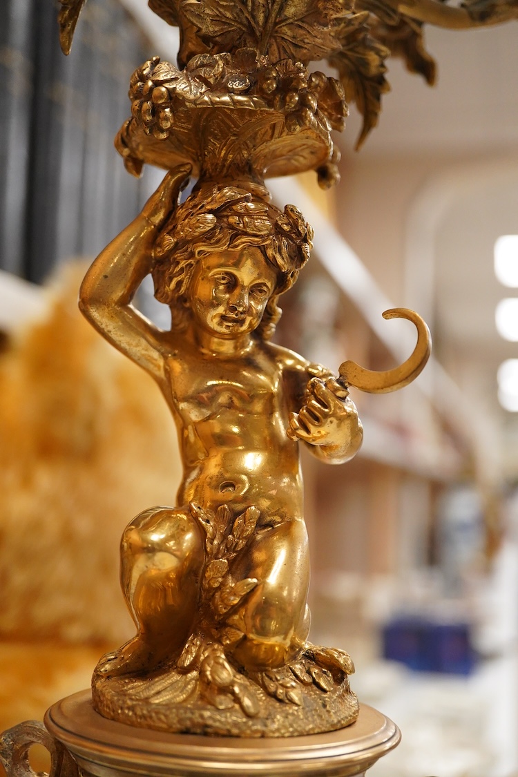 A pair of 19th century brass four light figural candelabra with inset enamel plaques, 48cm high